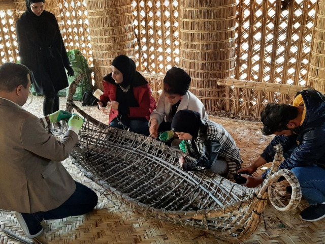 Students study boat model during Material Cultural Heritage Lab, 2021, Basra, Iraq (Rashad Salim / © Safina Projects, 2021)